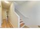 Staircase featuring white walls and hardwood floors at 5001 Baraldi Cir # 22-202, Sarasota, FL 34235