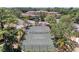 Aerial view of community tennis court surrounded by mature trees and landscaping at 5001 Baraldi Cir # 22-202, Sarasota, FL 34235