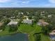 An aerial view showing the large lot, mature trees, lake, and beautiful pool in the backyard at 5012 Cherry Laurel Way, Sarasota, FL 34241