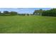 A large and well-maintained backyard lawn with a lake in the background at 5012 Cherry Laurel Way, Sarasota, FL 34241