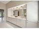Bright bathroom featuring double sinks, great lighting, and functional storage at 5012 Cherry Laurel Way, Sarasota, FL 34241