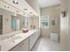 Bright bathroom with double sinks, a wide mirror, and great lighting at 5012 Cherry Laurel Way, Sarasota, FL 34241