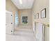 Relaxing bathroom with a soaking tub, natural light, and tiled floors at 5012 Cherry Laurel Way, Sarasota, FL 34241