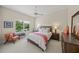 Cozy bedroom featuring neutral colors, a large window, ceiling fan and tasteful decor at 5012 Cherry Laurel Way, Sarasota, FL 34241