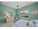 Serene bedroom with aqua walls, white furniture, and a view of the outdoors at 5012 Cherry Laurel Way, Sarasota, FL 34241