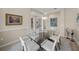 Open dining room showcasing a glass table with six chairs, artwork, and neutral paint at 5012 Cherry Laurel Way, Sarasota, FL 34241