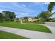 A lovely single-story home with mature landscaping, a manicured lawn, and a paved walkway at 5012 Cherry Laurel Way, Sarasota, FL 34241