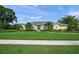 A well-maintained single-story home with lush landscaping, a manicured lawn, and large, bright windows at 5012 Cherry Laurel Way, Sarasota, FL 34241