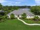 A landscaped single-story home with a well-maintained lawn and picturesque views of the adjacent lake at 5012 Cherry Laurel Way, Sarasota, FL 34241