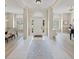 A grand foyer with tile floors, soaring ceilings, and views into the formal living and dining spaces at 5012 Cherry Laurel Way, Sarasota, FL 34241