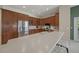 Kitchen featuring wood cabinets, stainless steel appliances, and a spacious quartz countertop bar at 5012 Cherry Laurel Way, Sarasota, FL 34241