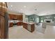 Bright kitchen with wood cabinets, stainless steel appliances, and an open layout to the living room at 5012 Cherry Laurel Way, Sarasota, FL 34241