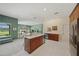 Open kitchen area featuring sleek countertops, stainless steel appliances, and seamless flow to the living room at 5012 Cherry Laurel Way, Sarasota, FL 34241