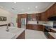 Well-equipped kitchen featuring wood cabinets, stainless steel appliances, and light countertops at 5012 Cherry Laurel Way, Sarasota, FL 34241