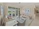 Inviting living room featuring sofas, armchairs, a glass table, and French doors with a view at 5012 Cherry Laurel Way, Sarasota, FL 34241