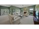 Spacious living room with fireplace, comfortable seating, and French doors to the outdoor area at 5012 Cherry Laurel Way, Sarasota, FL 34241