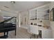 Spacious office featuring a grand piano, desk, and built-in bookcase with plenty of light at 5012 Cherry Laurel Way, Sarasota, FL 34241