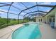 Stunning pool area featuring a screened enclosure, hot tub, and picturesque lake views at 5012 Cherry Laurel Way, Sarasota, FL 34241