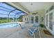 Inviting outdoor area with a screened pool, seating, and a scenic lake view at 5012 Cherry Laurel Way, Sarasota, FL 34241