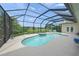 Beautiful screened-in pool area with hot tub, overlooking a serene lake at 5012 Cherry Laurel Way, Sarasota, FL 34241