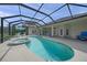 Screened-in pool with a spa and an area for lounging in the backyard of the home at 5012 Cherry Laurel Way, Sarasota, FL 34241