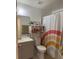 Clean bathroom featuring neutral walls, single vanity, toilet, and shower with a colorful curtain at 5026 Water Oak Dr # 114, Bradenton, FL 34207