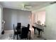 Dining room featuring modern black table and chairs adjacent to a bar with black barstools at 5026 Water Oak Dr # 114, Bradenton, FL 34207
