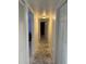 Hallway features carpet runner, neutral colors and doors that lead to other rooms of the home at 5026 Water Oak Dr # 114, Bradenton, FL 34207