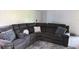 Comfortable living room showcasing a plush gray sectional sofa with pillows and convenient cup holders at 5026 Water Oak Dr # 114, Bradenton, FL 34207