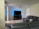 Comfortable living room featuring a plush gray sectional sofa, soft shag rug, and modern entertainment center at 5026 Water Oak Dr # 114, Bradenton, FL 34207