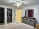 Cozy main bedroom with light-colored walls, ceiling fan and a dresser with a decorative mirror at 5026 Water Oak Dr # 114, Bradenton, FL 34207