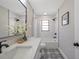 Bathroom featuring decorative tile floor, a large mirror, and a shower-tub combination at 5032 Barcelona Ave, Sarasota, FL 34235