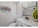 Modern half bathroom boasts marble counter tops and sleek vanity at 5032 Barcelona Ave, Sarasota, FL 34235