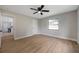 This bedroom features wood floors, a ceiling fan, a window, and a closet at 5032 Barcelona Ave, Sarasota, FL 34235