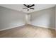 This bedroom features wood floors, a ceiling fan, a window, and a closet at 5032 Barcelona Ave, Sarasota, FL 34235