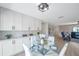 Bright and spacious dining area featuring built-in white cabinetry and a modern glass table at 5032 Barcelona Ave, Sarasota, FL 34235