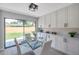 Bright dining area featuring glass table, white cabinetry and views of the backyard at 5032 Barcelona Ave, Sarasota, FL 34235