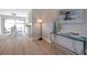 Stylish hallway leading to a bright dining area with a modern glass table and white chairs at 5032 Barcelona Ave, Sarasota, FL 34235