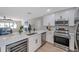 Modern kitchen with quartz counters and an open concept view to the living room and stainless steel appliances at 5032 Barcelona Ave, Sarasota, FL 34235