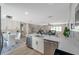 Spacious open floor plan kitchen and dining area with modern lighting and stainless steel appliances at 5032 Barcelona Ave, Sarasota, FL 34235