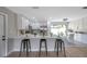 Modern kitchen with a quartz countertop island with bar seating and stainless steel appliances at 5032 Barcelona Ave, Sarasota, FL 34235