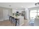 White kitchen boasts sleek stainless steel appliances, barstool seating, and quartz countertops at 5032 Barcelona Ave, Sarasota, FL 34235