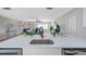 Open-concept kitchen featuring white countertops with stainless steel appliances overlooking the living room at 5032 Barcelona Ave, Sarasota, FL 34235