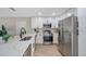 Bright kitchen with stainless steel appliances, modern cabinetry and bar seating at the counter at 5032 Barcelona Ave, Sarasota, FL 34235