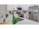 A well lit kitchen with stainless steel appliances and granite counters offers a sleek design at 5032 Barcelona Ave, Sarasota, FL 34235