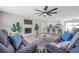 Bright living room features modern ceiling fan, fire place, and open floor plan to the kitchen at 5032 Barcelona Ave, Sarasota, FL 34235