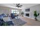 Bright living room with large window, fireplace, and modern furnishings creates an inviting atmosphere at 5032 Barcelona Ave, Sarasota, FL 34235