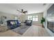 Inviting living room features a modern ceiling fan, fireplace, and a large window at 5032 Barcelona Ave, Sarasota, FL 34235