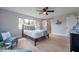 Bright main bedroom features a ceiling fan, a barn door to the bathroom, and a large window at 5032 Barcelona Ave, Sarasota, FL 34235
