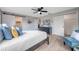 This main bedroom features wood floors, a ceiling fan, closet and a decorative art piece at 5032 Barcelona Ave, Sarasota, FL 34235